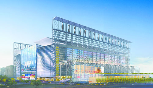 A large, modern stadium with a glass facade and a blue sky.