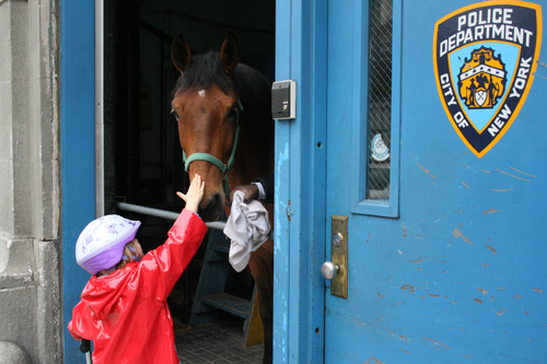 A preschooler petting a police horse back in 2011. Downtown Express file photo by Aline Reynolds.