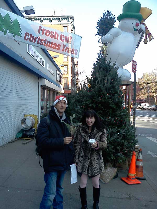 Faceboy holds our Christmas tree (branch), while Rev. Jen cradles coffee and nurses an office party hangover.