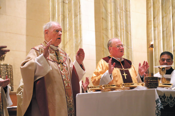 Former Archbishop Edward Egan, left, also participated in the dedication ceremony along with Dolan, center, much to the chagrin of activists who fought against Egan’s efforts to demolish the historic church.  Photos by Jefferson Siegel