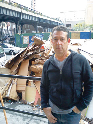 Photo by Scott Stiffler On Nov. 4, gallery owner Jack Shainman takes a break from consigning waterlogged basement items to the trash bin.