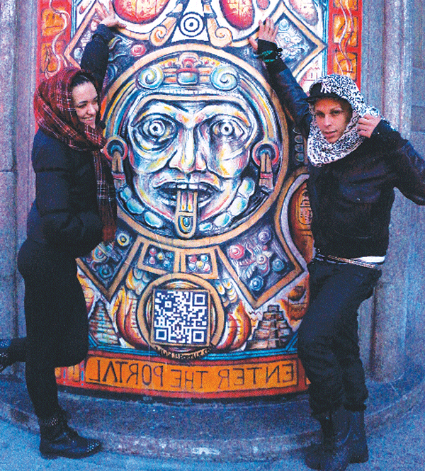 Passersby posed in front of Nicolina’s Portal 1 on Avenue C. It wasn’t known if they later disappeared through the portal only to re-emerge in ancient Yucatan.  Photo by Sarah Ferguson