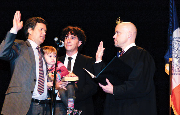 Hoylman took the oath of office, administered by Judge J. Paul Oetken, as his fiancé, David Sigal, held his bar mitzvah Bible for Hoylman to put his left hand on and they both cradled their daughter, Silvia, 2.  Photo by John Winkleman