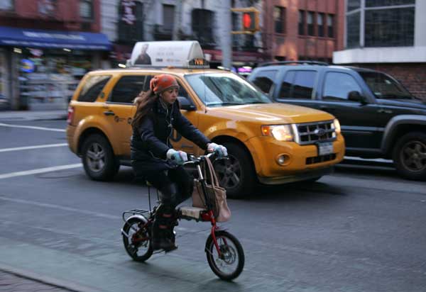 A cyclist traveled alongside vehicular traffic in the Prince St. bike lane near Sullivan St.  Downtown Express photo by Sam Spokony