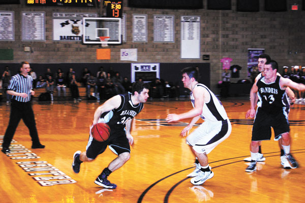 Photo by Daniel Jean-Lubin N.Y.U.’s Cory Stockmal defended as a Brandeis player tried to drive on him.