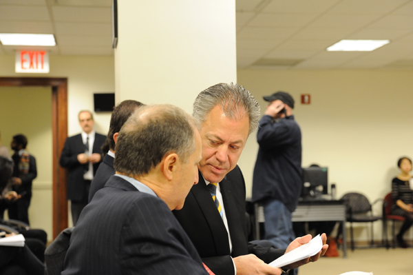 Chris Curry of The Howard Hughes Corp. confers with his firm's attorney, Paul Selver,  on March 14, before the hearing was moved to the City Council chambers.  Downtown Express photo by Terese Loeb Kreuzer