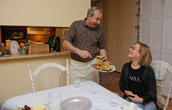 Gus Oranitsas, resident manager of Liberty Court and a TimeBank member, with Donna Rothkopf and a plate of spanakotiropita — spinach and feta cheese pie — that he showed TimeBank's "foodie" club how to make. Downtown Express photo by Terese Loeb Kreuzer.