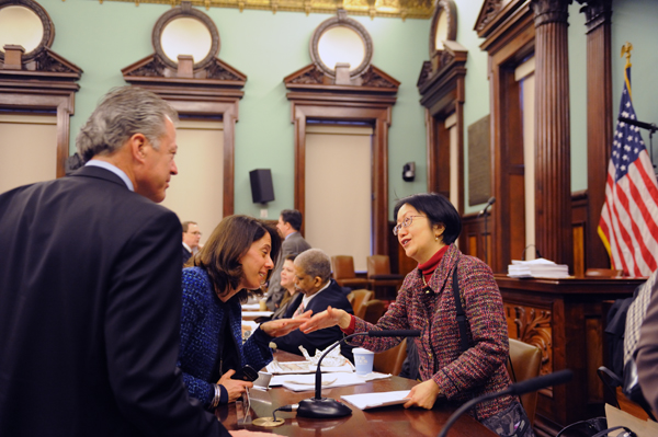 Councilmember Margaret Chin shakes hands with Julie Greenberg, a lobbyist for South Street Seaport Limited Partnership, which is part of  Howard Hughes Corp. Looking on is Christopher Curry, senior executive vice president of the Hughes firm.  Downtown Express photo by Terese Loeb Kreuzer