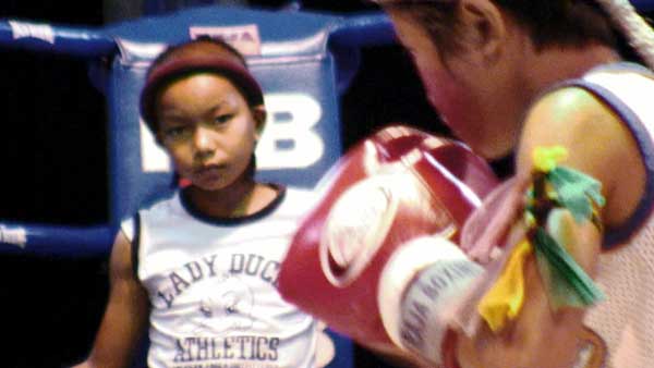 Photo courtesy of 108 Media Stam performs the Wai Kru before a fight as Pet looks on. 