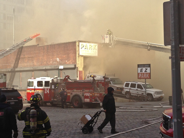 Two-alarm fire at Tribeca garage 1 Fire broke out at 10 a.m., spewing smoke into Greenwich St. as those with cars in the garage looked on. Downtown Express photo by Tequila Minksy