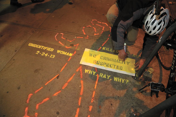 Late last Thursday night, a bicycle activist stenciled at Third Ave. and 27th St. where, on Feb. 24, a still-unidentified pedestrian was killed after a car and cab collided, sending the car jumping the curb onto the sidewalk.  Photo by Jefferson Siegel 