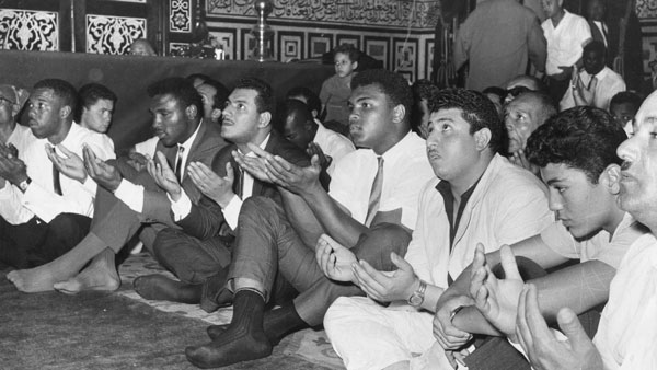Photo courtesy of Express/Archive Photos/Getty Images Ali (front row, fourth from right) prays at the Hussein Mosque in Cairo in June 1964, four months after changing his name from Cassius Clay and announcing he is a member of the Nation of Islam (a scene from the upcoming Tribeca Film Festival documentary, “The Trials of Muhammad Ali”).