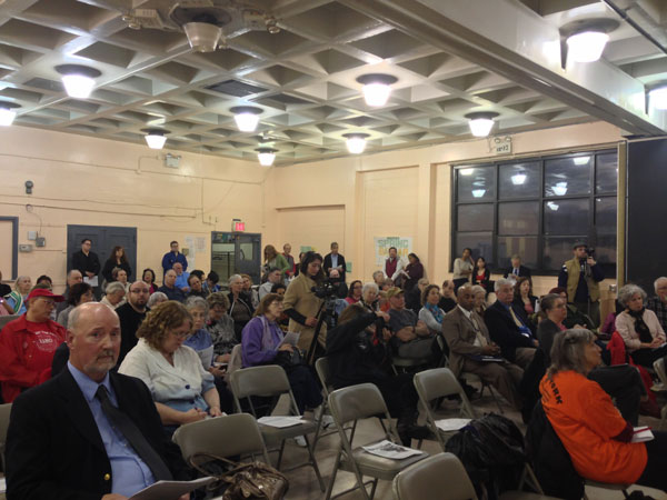 At Public Forum, Little New on USPS Plans for Old Chelsea Station 1 Photo by Maeve Gately On April 11, at Fulton Auditorium, Chelsea residents gathered in Fulton Auditorium to voice their opinions; USPS representative Joseph J. Mulvey (foreground, left) listens to the complaints.