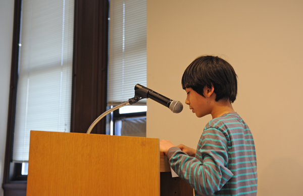 Kai Mandelbaum, 9, testified at the Landmarks Preservation Commission hearing on the Seward Park Branch Library. "A lot of my classmates are immigrants," he said "Libraries are really important to them. I know that the library is not going to get knocked down right now, but I think we should landmark it now so that nobody will try to knock it down later." (Photo: Terese Loeb Kreuzer)