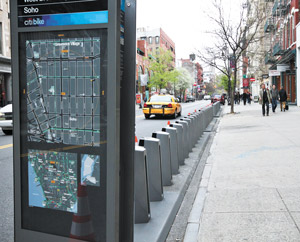 Photo by Tequila Minsky This new bike-share station for 40-plus bikes on West Broadway is planted next to a strip coveted by sidewalk artists on weekends.