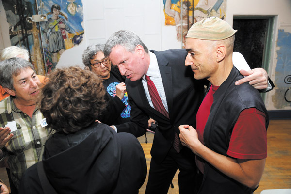 Photos by Jefferson Siegel After speaking at Monday night’s mayor candidates forum, Bill de Blasio greeted audience members, including Little Italy activist Sante Scardillo, right, and Elaine Young, far left.