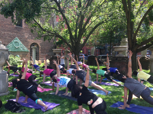 Free Sunday yoga classes draw a big crowd at the Elizabeth St. Garden. File photo by Erum Hasnain.