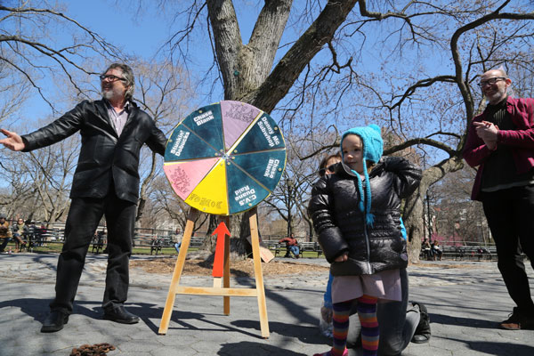 Photo by Jefferson Siegel Bob Holman, left, and Rob Hollander invited neighborhood children to spin the “Community Wheel of Fortune.”