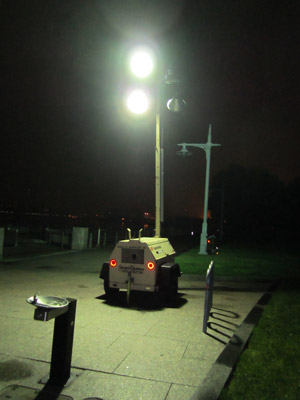 Photo by Lincoln Anderson On Tuesday night at 11:30 in Hudson River Park, temporary floodlights powered by a portable generator illuminated the park’s esplanade near Bank St., where the park’s AIDS memorial is located. Most of the park’s Village section, however, was without any electrical light at all and the park remained closed during evening hours. Normally, the park is open until 1 a.m., but has been closing at dusk ever since Hurricane Sandy knocked out its electrical power seven months ago.