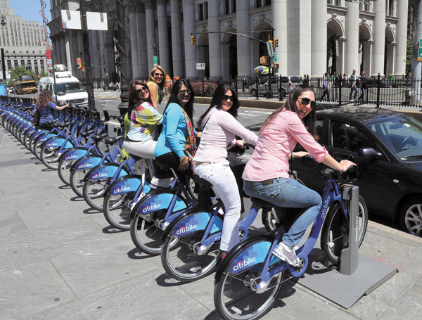 Downtown Express photos by Jefferson Siegel Tourists near City Hall gave the bike seats a try.