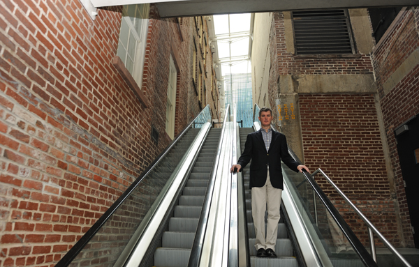 The nuts and bolts of the Seaport Museum’s Sandy damage 1 Jerry Gallagher, general manager of the South Street Seaport Museum, standing on the escalator that was damaged by Superstorm Sandy. On one side of him are the 12 Fulton St. galleries. On his other side is the museum's John St. building where the museum's offices and collection storage are housed. Downtown Express photo by Terese Loeb Kreuzer.