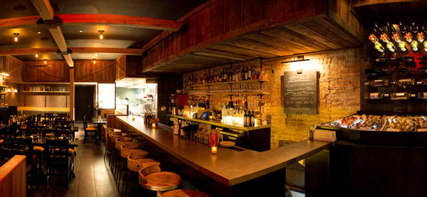The interior of Ichabod’s features exposed brick and wood beams, as well as a large raw bar.