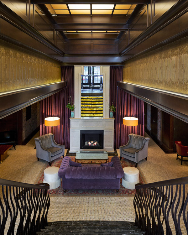 The Jade Hotel has a dramatic entrance leading down a flight of black stairs to a lounge area with a working fireplace.