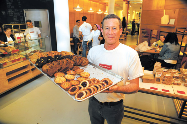 Photo by Jefferson Siegel Master baker Uri Scheft with a tray of tantalizing treats at Breads Bakery. 