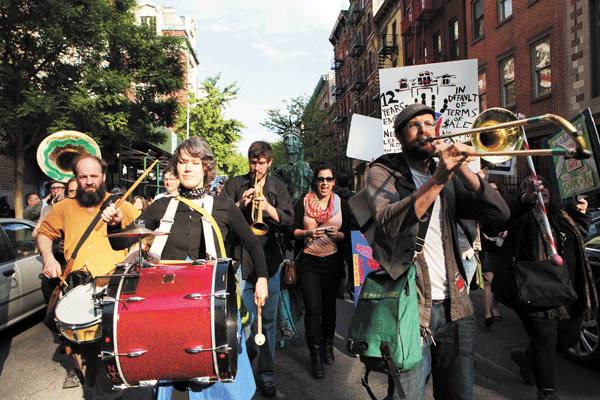 Photos by Q. Sakamaki The protesters gathered outside the old P.S. 64, at Ninth St. near Avenue B, below, then marched over to Cooper Union’s Foundation Building on Cooper Square, to the strains of the Hungry March Band, above.