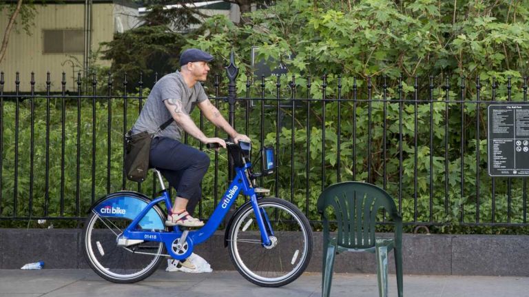 Fund smaller parks from the city budget 2 A man rides a Citi Bike at City Hall Park in downtown Manhattan. (May 27, 2013)