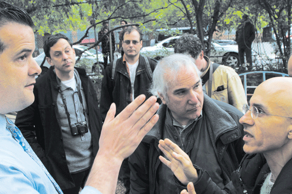 Photo by Clayton Patterson Aresh Javadi, far right, and environmental attorney Joel Kupferman, second from right, spoke to a representative of developer Serge Hoyda, left, at the Children’s Magical Garden on Wednesday.