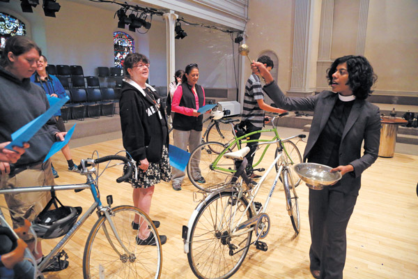 Church service blesses ‘the spirit in the wheels’ 1 Downtown Express Photo by Jefferson Siegel Reverend Winnie Varghese sprinkled holy water on cyclists’ rides at the first blessing of the Bicycles.