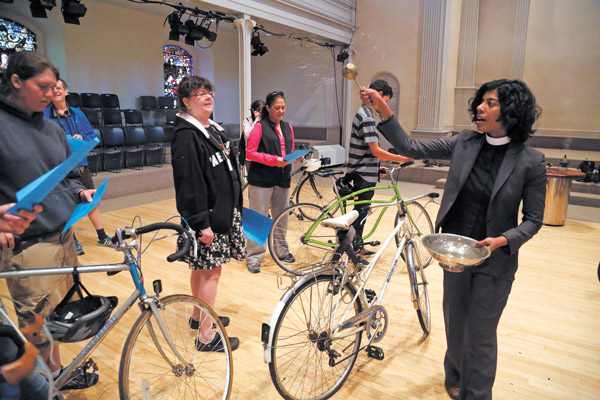 Downtown Express Photo by Jefferson Siegel Reverend Winnie Varghese sprinkled holy water on cyclists’ rides at the first blessing of the Bicycles.