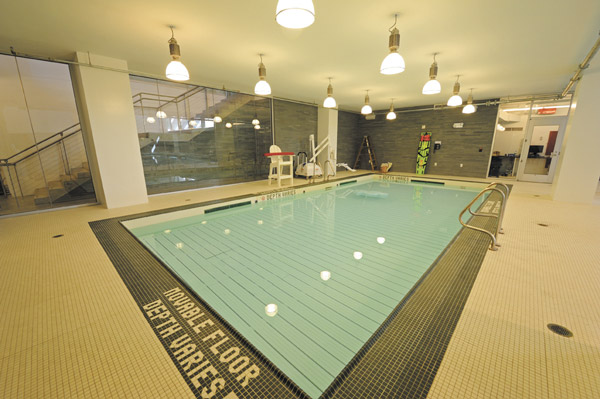 Photo courtesy of the Battery Park City Authority Asphalt Green’s movable floor pool, above, which opens June 15 along with the rest of the center, is designed for wheelchair users and crawling babies. Below, the gym, and at bottom, the center’s flooded area last year, three days after Superstorm Sandy hit.   