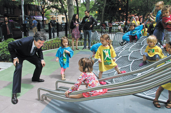 Photos by Tequila Minsky As University Plaza preschoolers looked on, state Senator Brad Hoylman greeted his daughter, Silvia, as she zipped down the dragon play slide’s tongue in Adrienne’s Garden.
