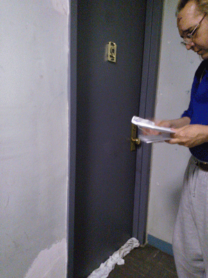 Photo by Clarissa Jan-Lim Bohdan Rekshynskyj visited his building last week at Village View, but was not allowed access to his apartment. In the photo above, he picked up what he called a letter of support that had been left outside his door.