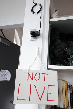 A sign under an Internet video camera lets occupiers know if the Livestream feed is on.