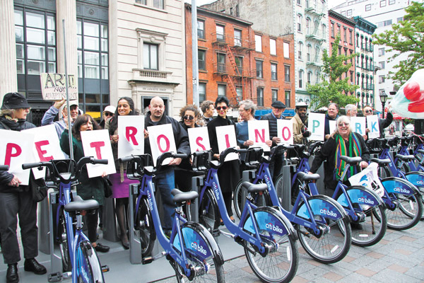 Downtown Express photo by Tequila Minsky Standing behind racks of parked Citi Bikes, protesters held cards spelling “ART IN PETROSINO PARK.” Council hopeful Jenifer Rajkumar held the “R.”