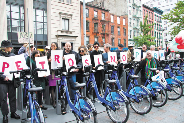 Photos by Tequila Minsky Standing behind the rack of parked Citi Bikes, the protesters held up cards spelling “ART IN PETROSINO PARK.” (The people holding up the “ART IN” cards couldn’t fit into this photo.)