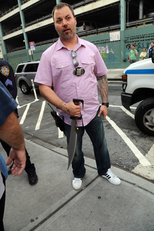 Downtown Express photo by Jefferson Siegel A plainclothes officer from the Fifth Precinct holding a 16-inch sword that allegedly had been carried by Morgan Soto.