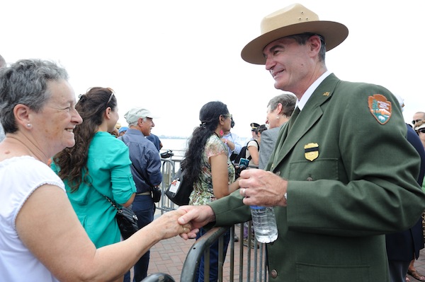 David Luchsinger, superintendent of Liberty and Ellis Islands, shook hands with visitors on July 4 2013, the day that Liberty Island reopened after being closed for eight months because of Superstorm Sandy damage. Luchsinger said he found it "heartwarming" that about 20,000 people came to the island on opening day, Downtown Express photo by Terese Loeb Kreuzer.