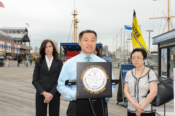 City Comptroller John Liu, flanked by members of his audit staff, at a July 25 press conference outside Pier 17.  Downtown Express photo by Terese Loeb Kreuzer