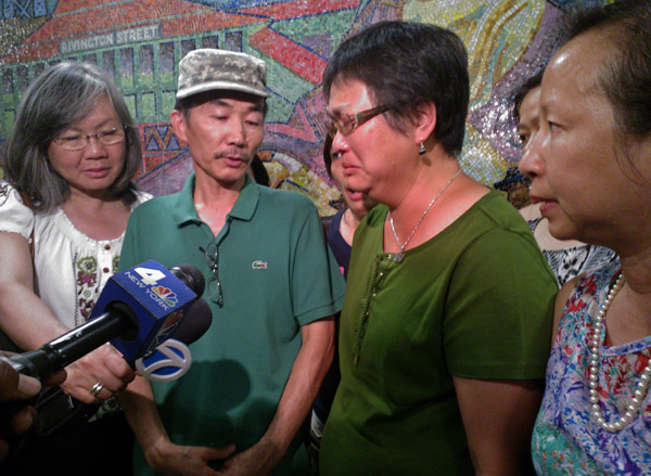 Downtown Express Photo by Clarissa-Jan Lim After winning the community board’s approval for a street co-naming sign for her son, Danny Chen’s mother, Su Zhen Chen, right, with her husband, Yan Tao Chen, center, tearfully thanked supporters, but said the pain of losing her only child will never go away.