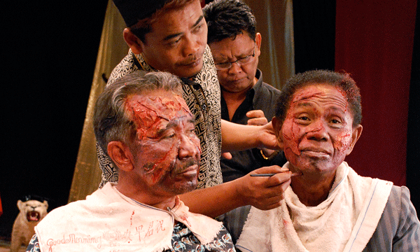 Anonymous/ Courtesy: Drafthouse Films Anwar Congo (r.) being made up for a film in which he plays a victim of the torture he and his allies unleashed on opponents in Indonesia.