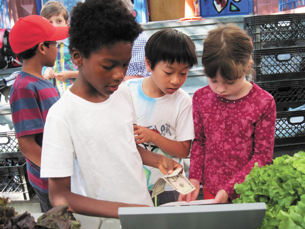 Math class moves outdoors as students count change for customers. 