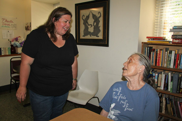 Laura Marceca, the director of Caring Community at 20 North Washington Square North, left, spoke with Marie Finley, a frequent visitor to the senior center, particularly for lunch and movie screenings. “Is it cool enough?” asked Marceca last Friday, one of the hottest days during last week’s heat wave. “It's terrific,” responded Finley. The air-conditioned center off Washington Square Park is designated as one of the city’s cooling centers.  Photo by Tequila Minsky 