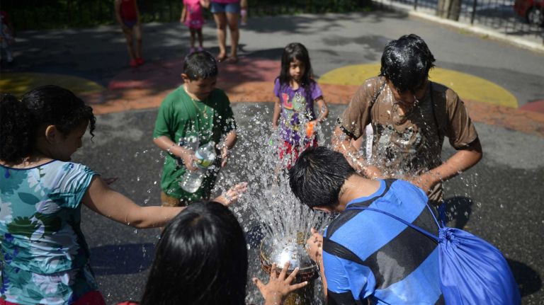 Jackson Heights 15 Kids beat the heat by soaking themselves under a fountain in Northern Park at 93rd Street and Northern Boulevard. (June 15, 2013)