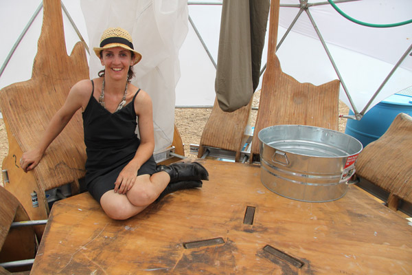 Beyond Eco Dome: Mary Mattingly, seated above, is creating “Triple Island,” a unique eco exhibit with a geodesic dome-like structure. Outside the dome, free fishing gear and lessons are being provided. The trees in the planters, below, will eventually go to nearby NYCHA complexes, but for now provide shade on the East River waterfront.   Downtown Express photos by Tequila Minsky 