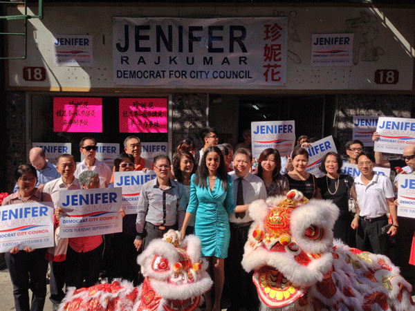Jenifer Rajkumar, center, with supporters and lions, at the opening of her new Pell St. campaign office on Sunday.