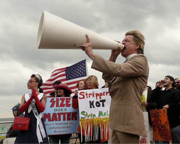 Photos by Amy Nicholson Megaphone in hand, Rev. Billy lends his voice to the protest.
